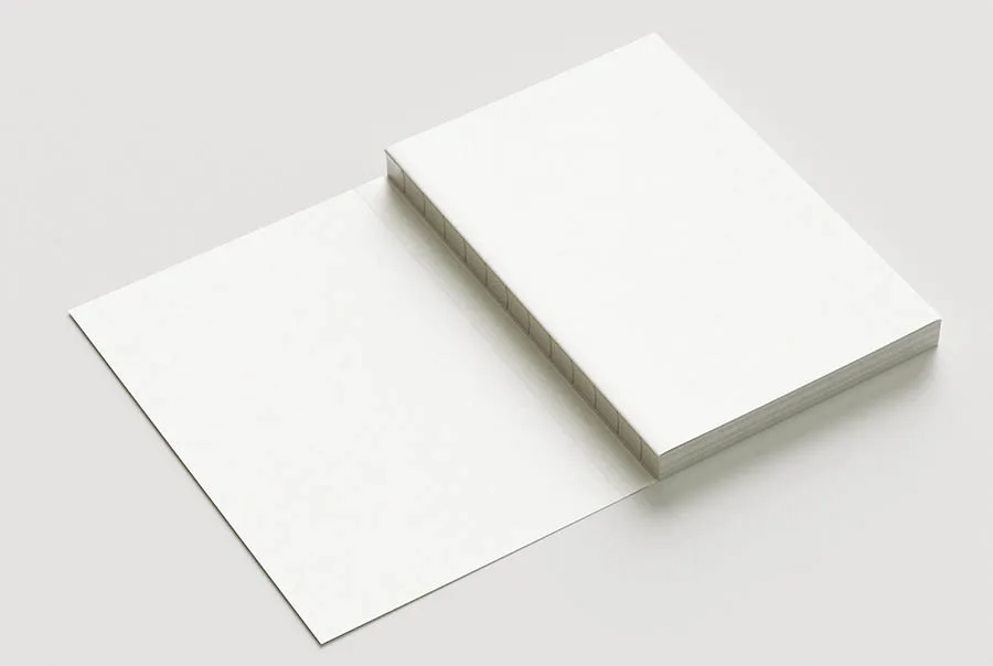Blank white Swiss-bound book with exposed inner spine, viewed at an angle on a pale gray background.