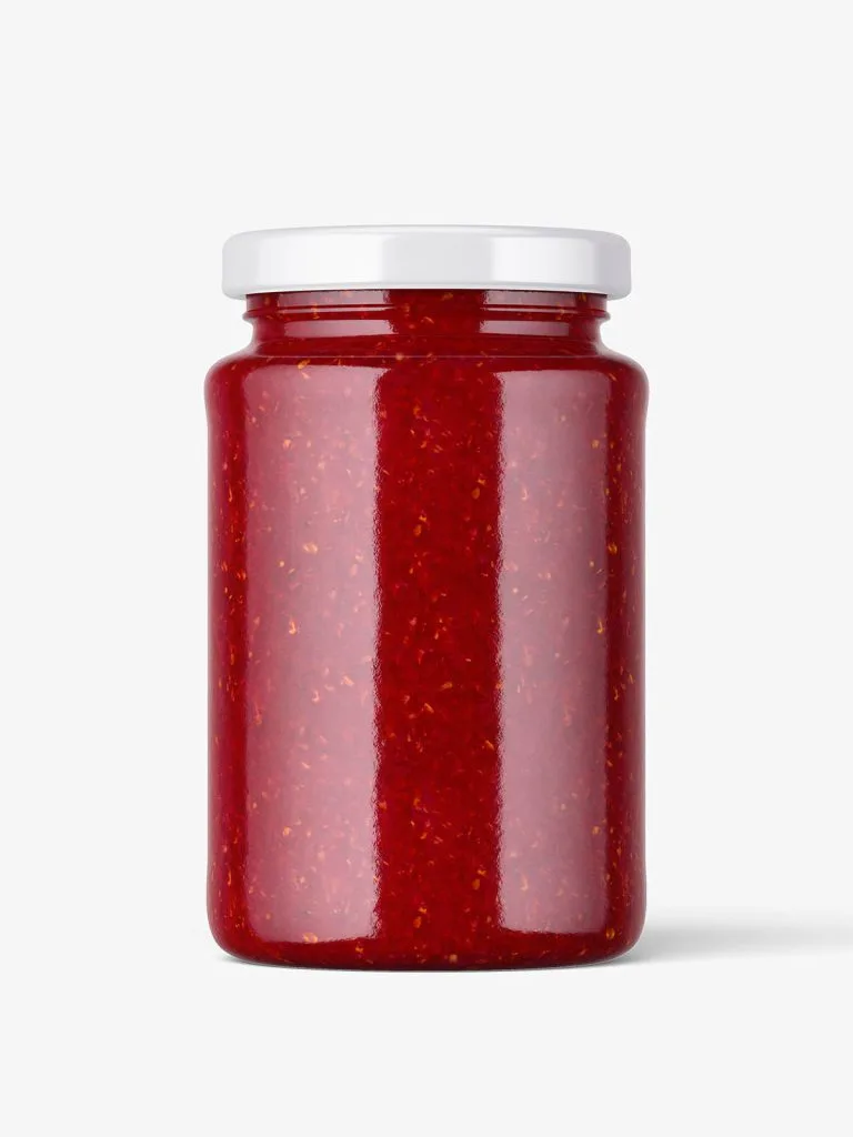 An unlabelled glass jar filled with red preserves and topped with a silver lid.